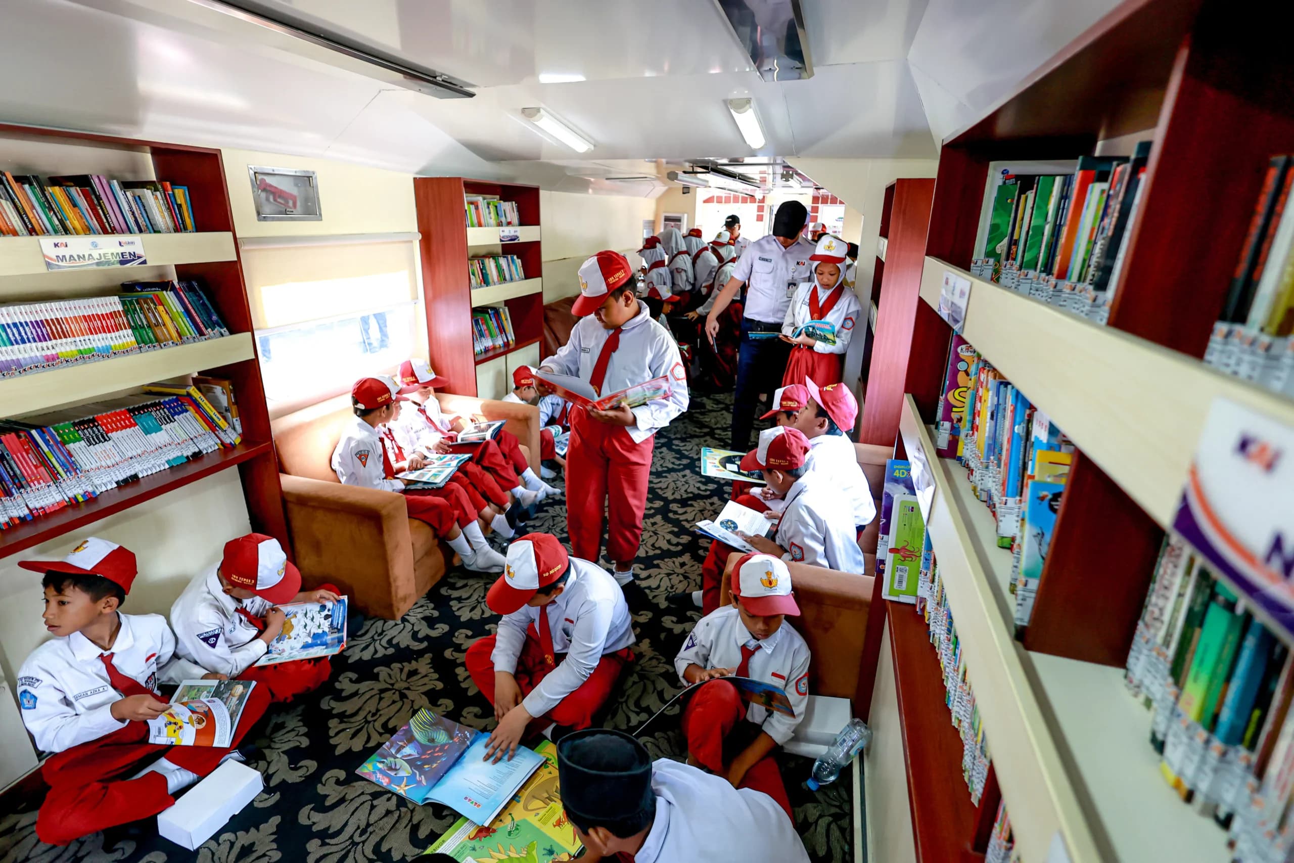 Sejumlah siswa membaca buku saat layanan Perpustakaan Kereta oleh PT Kereta Api Indonesia (Persero) di Stasiun Geneng, Ngawi, Jawa Timur